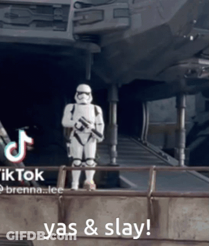 A Storm Trooper Is Standing In Front Of A Building With The Words Yas & Slay Behind Him GIF