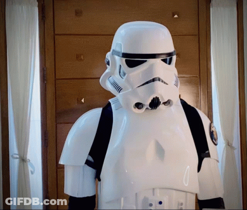 A Storm Trooper Stands In Front Of A Wooden Dresser GIF