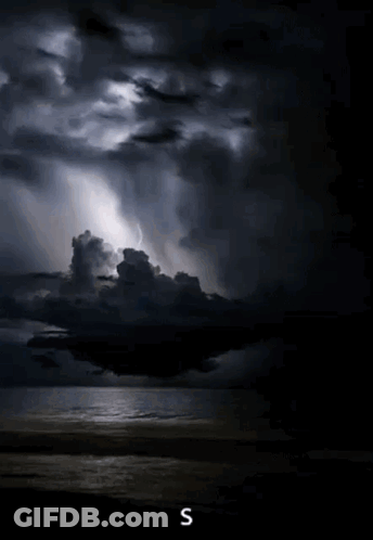 A Stormy Sky Over A Body Of Water With The Letter S On The Bottom Right GIF
