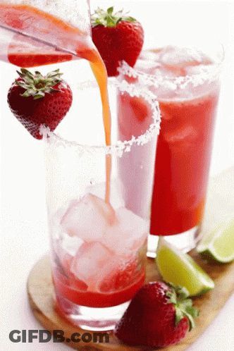 A Strawberry Margarita Being Poured Into A Glass With Ice GIF