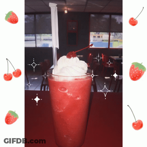 A Strawberry Milkshake With Whipped Cream And A Cherry On Top Of It GIF