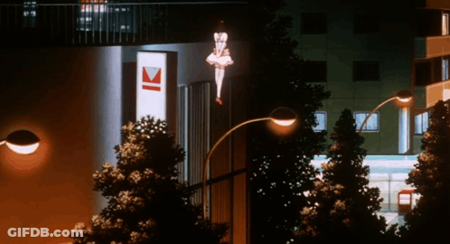 A Street Light Is Lit Up In Front Of A Building With The Letter K On It GIF