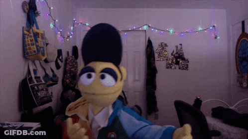 A Stuffed Animal In A Room With A Bag That Says ' A ' On It GIF