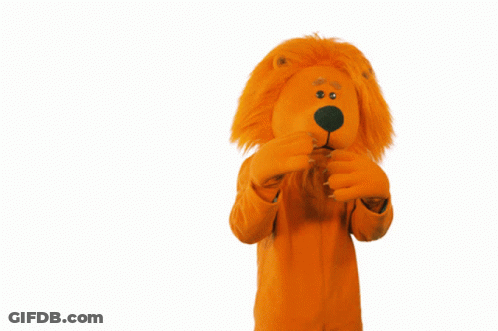 A Stuffed Animal In An Orange Lion Costume Covering Its Mouth GIF