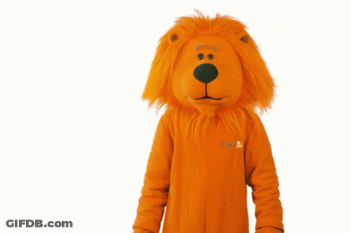 A Stuffed Animal In An Orange Lion Costume That Says ' Snl ' On The Front GIF