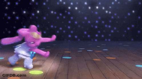 A Stuffed Animal Is Dancing On A Wooden Floor GIF