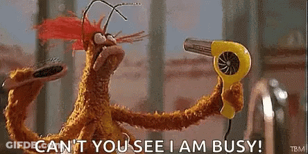 A Stuffed Animal Is Holding A Yellow Hair Dryer And Saying `` Can 'T You See I Am Busy '' . GIF