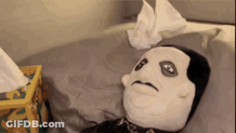 A Stuffed Animal Is Laying On A Bed With A Box Of Kleenex Next To It GIF