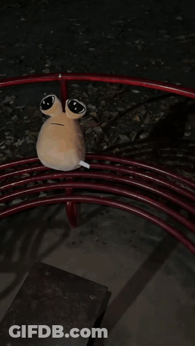 A Stuffed Animal Is Laying On Top Of A Red Swirl GIF