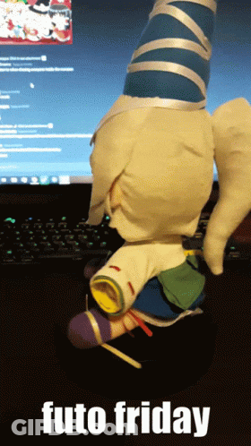 A Stuffed Animal Is Sitting In Front Of A Computer Screen With The Words Futo Friday Below It GIF