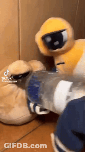 A Stuffed Animal Is Standing Next To A Bottle Of Water And A Pair Of Slippers . GIF
