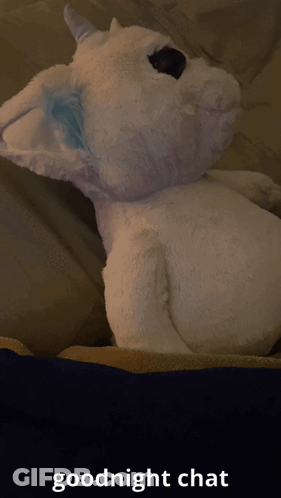 A Stuffed Animal Laying On A Bed With The Words " Goodnight Chat " Below It GIF