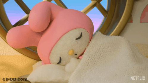 A Stuffed Animal Sleeping On A Bed With A Blanket That Says Netflix GIF