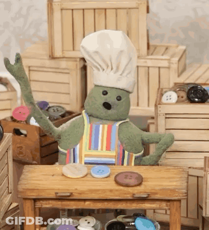 A Stuffed Animal Wearing A Chef 'S Hat And Apron GIF