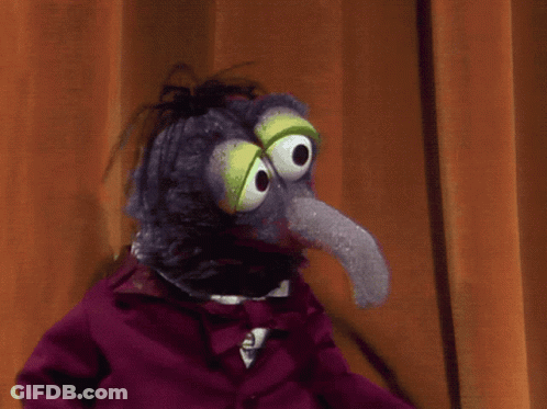 A Stuffed Animal With A Long Tongue And Big Eyes GIF