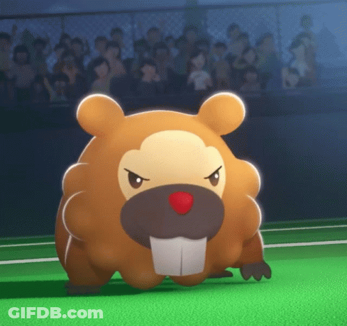 A Stuffed Animal With A Red Nose Is Standing On A Green Field In Front Of A Crowd GIF