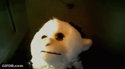 A Stuffed Animal With A Sad Face Is Sitting On A Table GIF