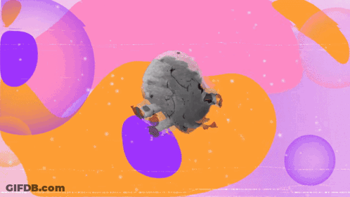 A Stuffed Animal With A Smiley Face And Black Spots On It GIF