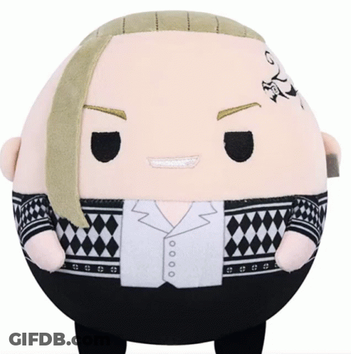 A Stuffed Animal With A Tattoo On His Forehead Is Sitting On A Table GIF