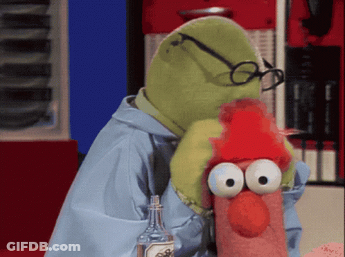 A Stuffed Animal With Glasses And A Red Hat Is Holding A Bottle GIF