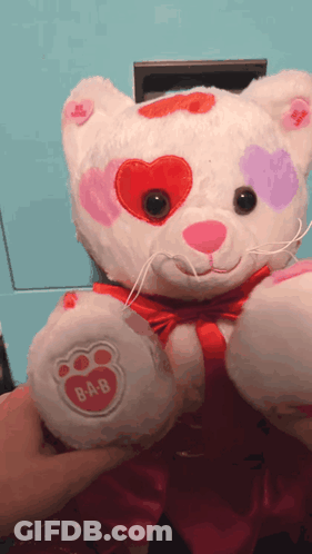 A Stuffed Animal With Hearts On Its Eyes And A Paw That Says B-A-B On It GIF
