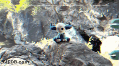 Horned Stuffed Animal Sitting On Rock GIF
