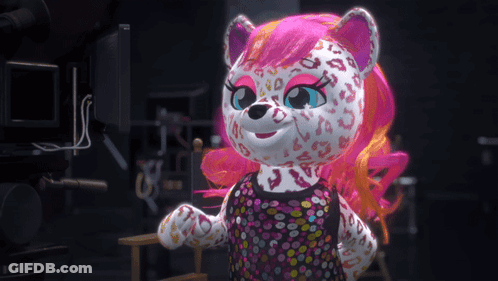 A Stuffed Animal With Pink Hair And A Leopard Print Is Standing In Front Of A Camera GIF