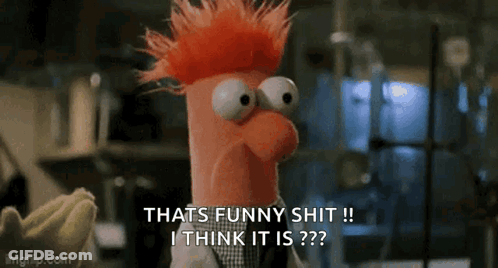 A Stuffed Animal With Red Hair And Big Eyes Is Talking About Something Funny . GIF