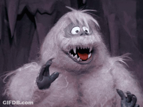 A Stuffed Animal With Sharp Teeth And A Tongue Out GIF