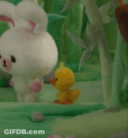 A Stuffed Bunny And A Stuffed Duck Are Standing Next To Each Other In The Grass GIF