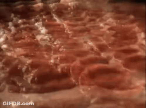 A Stuffed Crust Pizza Is Being Eaten With A Fork GIF
