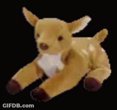A Stuffed Deer Is Laying Down On A Black Background And Looking At The Camera . GIF