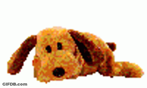 A Stuffed Dog Is Laying Down On A White Surface . GIF
