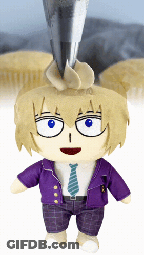 A Stuffed Doll In A Purple Jacket And Tie Is Standing In Front Of Cupcakes Being Frosted GIF