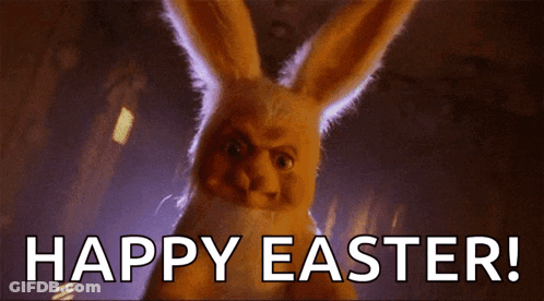 A Stuffed Easter Bunny Is Standing In The Dark And Says Happy Easter . GIF