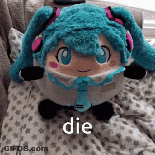A Stuffed Hatsune Miku Doll Is Laying On A Bed With The Word Die Below It GIF