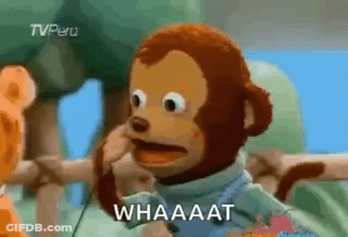 A Stuffed Monkey Is Making A Funny Face And Talking On A Cell Phone . GIF