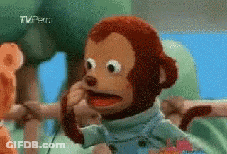 A Stuffed Monkey Is Making A Funny Face While Sitting In A High Chair . GIF