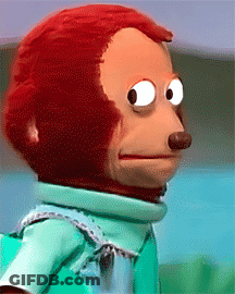 A Stuffed Monkey Wearing A Green Shirt Is Making A Funny Face GIF