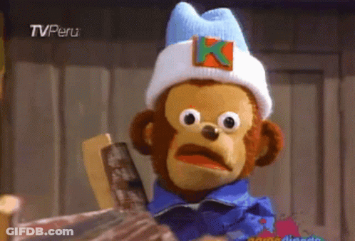 A Stuffed Monkey Wearing A Hat With A Letter K On It GIF