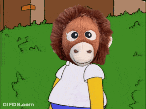 A Stuffed Monkey Wearing A White Shirt And Blue Pants GIF