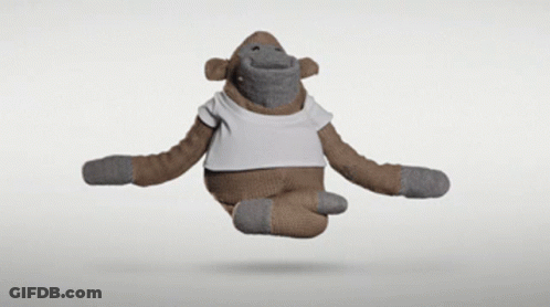 A Stuffed Monkey Wearing A White T-Shirt Is Flying Through The Air GIF
