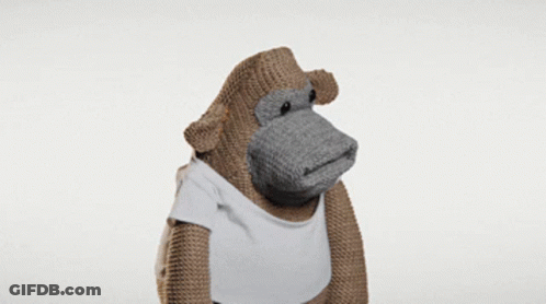 A Stuffed Monkey Wearing A White T-Shirt GIF
