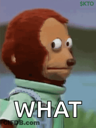 A Stuffed Monkey With A Green Shirt And The Word What On It GIF