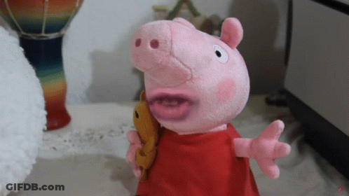 A Stuffed Pig With A Red Dress And A Yellow Fish In Its Mouth GIF