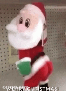 A Stuffed Santa Claus Is Standing On A Shelf In A Store And Holding A Green Cup . GIF