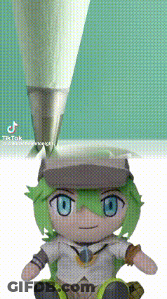 A Stuffed Toy With Green Hair And Blue Eyes Is Sitting Next To A Pencil . GIF