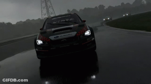A Subaru Is Driving Down A Wet Road In The Rain GIF