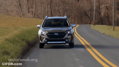 A Subaru Suv Is Driving Down A Road With Motorweek.org Written In The Corner GIF