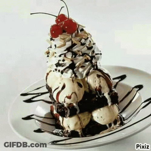 A Sundae With Ice Cream , Chocolate Sauce , Whipped Cream And A Cherry On Top On A Plate . GIF